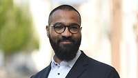 Ein Portraitbil des Protagonisten in seinem Businessdress