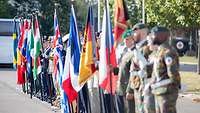 Soldiers are holding their national flags