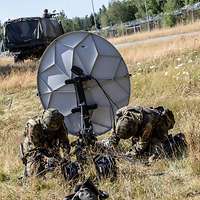 Zwei Soldaten bauen eine Satellittenschüssel auf