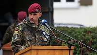 Ein Soldat steht hinter einem Rednerpult.