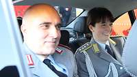 Zwei Soldaten im Dienstfahrzeug der Bundeswehr.