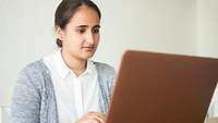 Manavdip Singh-Bhangus sits at laptop PC