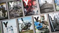 Verschiedene Ausgaben des Y-Magazins nebeneinander