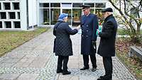 Spenden sammeln für Kriegsgräber Eine Frau steckt Geld in die Sammelbüchse, die Brigadegeneral Michael Traut hält. Daneben steht Oberbürgermeister Erich Raff.