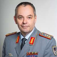 Ein Soldat im Dienstanzug schaut freundlich in die Kamera.