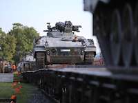 Soldat fährt einen Schützenpanzer Marder auf einen Güterwagon. Schützenpanzer Marder auf einem Güterwagon.