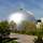 The target simulation dome at WTD 81 in Greding Hemispherical target simulation dome at WTD 81 in Greding with trees and a lawn in the foreground.