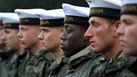 Bundeswehr soldiers of different origins stand in a row