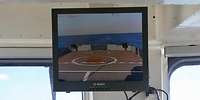 Ein Monitor, der ein Videobild vom Flugdeck auf die Brücke überträgt 