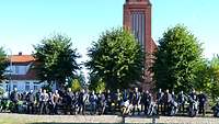 Gruppenbild der Biker vor ihren Motorrädern vor einer Kirche