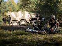Medics of the Bundeswehr Medical Service provide casualty care Two medics provide medical care to a casualty in front of a MRAV Boxer