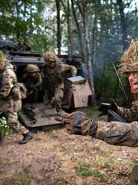 Branches of the Army Armoured infantry dismount from their vehicle.