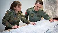 Map talks: an aeronautical information service sergeant advises a pilot.