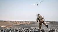 An ISR soldier on operations hand-launches a drone.