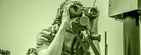 Different methods of collecting information: A soldier of the ISR Corps uses binoculars to observe the terrain. A soldier uses binoculars to observe from within a vehicle.