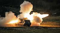 With an enormous jet of fire, a rocket launcher fires off an artillery missile.