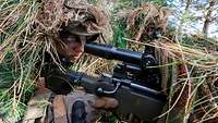 Two snipers lie in position with their G22 rifles.