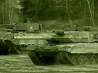 Various types of main battle tank (MBT) and infantry fighting vehicle (IFV) constitute the primary weapon systems of the armoured forces. A Leopard 2 MBT traverses open ground alongside a Marder IFV.