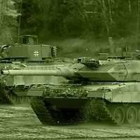 A Leopard 2 MBT traverses open ground alongside a Marder IFV.