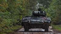 A Puma IFV traverses wooded terrain.