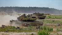 A Marder IFV traverses open ground alongside a Leopard 2 MBT.