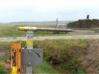 Pressure sensor for the detonation before the explosion A big metal bar with cables on a ground-mounted bracket