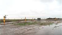 Test setup at WTD 91 with bombs and pressure sensors The bombs are standing on muddy ground, surrounded by pressure sensors
