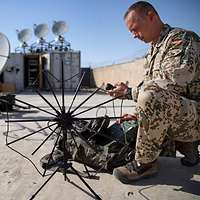 Ein Soldat baut eine Antenne auf.