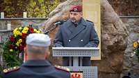Ein Soldat steht an einem Rednerpult und spricht