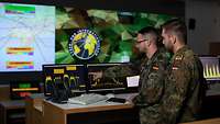 soldiers look at a monitor