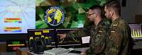 Cyber an Information Domain soldiers look at a monitor