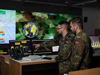 Cyber an Information Domain soldiers look at a monitor