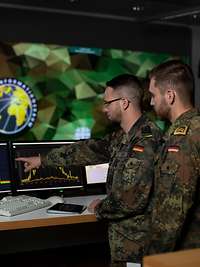 Cyber an Information Domain soldiers look at a monitor