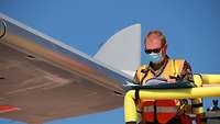 Ein Soldat schaut in einen Ordner und checkt den Airbus A330.