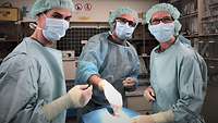 Drei Ärzte behandeln einen Patienten im OP-Saal