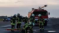 Feuerwehrleute sind an einem Verteiler beschäftigt