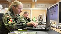 Soldiers in front of computers.