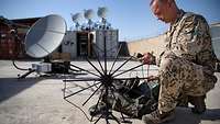 A soldier with a SATCOM-system.