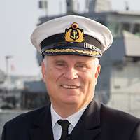 A navy officer in uniform.