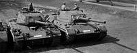 Demonstration of standard and cannon tanks and the operational readiness of the army in 1963 in Munster Black and white shot of tanks and helicopters in the field