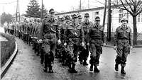 Black-and-white photo of soldiers in a column on the Andernach barracks