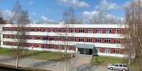 Blick von oben auf ein modernen dreistöckigen Block mir rot-weißer Verblendung