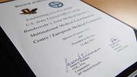 a signed certificate lying on a table