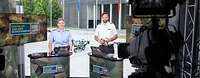 Eine Soldatin und ein Soldat stehen in einem Fernsehstudio