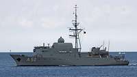 A grey warship at sea.