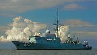 A grey warship at sea.