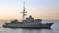 A grey warship at sea.