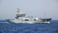 A grey ship at sea.