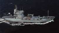 A grey ship at sea.