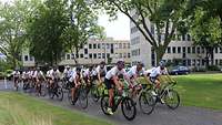Eine Gruppe Fahrradfahrer, neben und hintereinander fahrend.